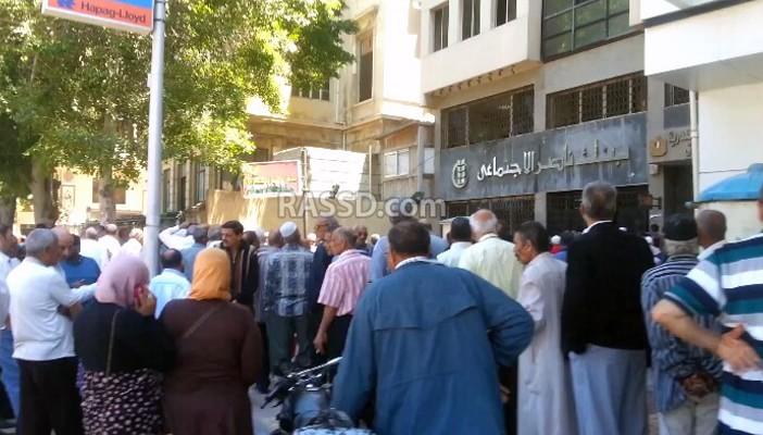 بالصور.. زحام وتدافع بالأيدي أمام بوابات بنك ناصر بالإسكندرية